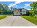 Beautiful home with a spacious driveway and lush green lawn at 2102 Braswell Ln, Loganville, GA 30052