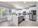 Bright kitchen featuring white cabinets, stainless appliances, kitchen island, and modern finishes at 2102 Braswell Ln, Loganville, GA 30052
