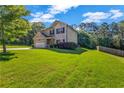 Beautifully kept lawn with mature trees surrounding the home at 2102 Braswell Ln, Loganville, GA 30052