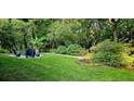 Serene backyard showcasing a fire pit area and lush greenery, creating a peaceful outdoor retreat at 2804 Dunnington Cir, Chamblee, GA 30341