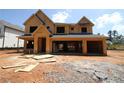 Unfinished two-story home with a three-car garage and a partially covered front porch on a construction site at 452 Maypop Lane, Woodstock, GA 30188