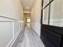 Bright, airy foyer with hardwood flooring, modern wainscoting, and a glass-paneled front door at 5704 Urban Village Way # 3, Tucker, GA 30084