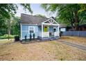 View of a blue home with a front porch, green door, and landscaping at 106 Adair Ave, Atlanta, GA 30315