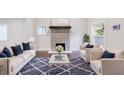 Bright living room with fireplace, hardwood floors, neutral furniture, and pops of blue at 106 Adair Ave, Atlanta, GA 30315