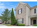 Close-up of brick and siding townhome, showcases architectural detail and landscaping at 2555 Flat Shoals Rd # 801, Atlanta, GA 30349