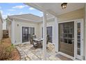 Cozy outdoor patio featuring stone pavers, a dining table, and sliding door access to the home's interior at 329 Acuba Vw, Woodstock, GA 30188