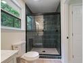 Bathroom with a new glass shower door and modern tiling at 8432 Magnolia Dr, Jonesboro, GA 30238