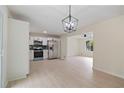 Open concept kitchen features stainless steel appliances and modern lighting fixtures at 8432 Magnolia Dr, Jonesboro, GA 30238