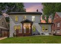 Charming white brick home featuring a welcoming front porch and beautifully manicured lawn at 1721 S Gordon Sw St, Atlanta, GA 30310