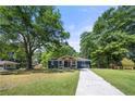 Quaint home with lush trees and a long driveway at 3770 Ponderosa Ln, Powder Springs, GA 30127
