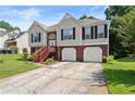 Charming two-story home with a well-maintained lawn and an inviting entrance and two-car garage at 4303 Anderson Ridge Dr, Austell, GA 30106