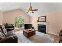 Cozy living room featuring a fireplace, large window, plush seating, and hardwood floors at 4303 Anderson Ridge Dr, Austell, GA 30106