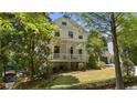 Beautiful two-story house with a classic porch and lush front yard landscaping at 4495 Westgate Dr, Cumming, GA 30040