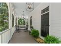 Inviting front porch with rocking chairs, stylish lighting, and a welcoming entrance at 4495 Westgate Dr, Cumming, GA 30040