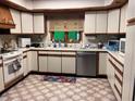 Traditional kitchen features stainless steel appliances, wood trim, and abundant counter space at 4961 Ivey Road, Acworth, GA 30101