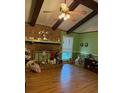 A charming living room features a brick fireplace, hardwood floors, and bright green walls at 4961 Ivey Road, Acworth, GA 30101