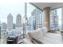 Living room featuring floor-to-ceiling windows offering panoramic city views at 1080 Ne Peachtree Ne St # 2802, Atlanta, GA 30309