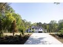 Beautiful home with a long driveway and lush landscaping at 3681 Hamilton Mill Rd, Buford, GA 30519