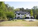 Stunning modern two-story home with manicured lawn and ample greenery at 3681 Hamilton Mill Rd, Buford, GA 30519