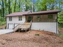 Charming ranch-style home featuring a two-car garage, stone accents, and a welcoming front porch at 641 Charing Cross Dr, Marietta, GA 30066