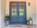 Inviting front door with sidelights, a welcome mat, and charming decorative lanterns at 641 Charing Cross Dr, Marietta, GA 30066