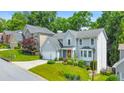 View of a well-maintained house with lush green lawn, mature trees, and neighborhood setting at 70 Parkside Cir, Marietta, GA 30068