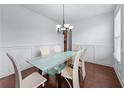 Dining area featuring hardwood floors and a glass top dining table at 3422 Hopi Pt, Lawrenceville, GA 30044