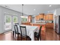 Kitchen dining area featuring hardwood floors, ample cabinets, granite countertops, and stainless steel appliances at 3422 Hopi Pt, Lawrenceville, GA 30044