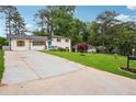 Lovely white brick house with a long driveway, green lawn, and inviting curb appeal at 2240 Clanton Ter, Decatur, GA 30034