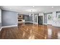 Open-concept living room with hardwood floors, a stone fireplace, and modern lighting fixtures at 2240 Clanton Ter, Decatur, GA 30034
