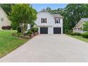 Spacious two-car garage with a long driveway and manicured landscaping at 387 Rose Creek Pl, Woodstock, GA 30189