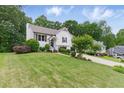 Beautiful two-story home with a green lawn, attractive landscaping, and a two-car garage at 387 Rose Creek Pl, Woodstock, GA 30189