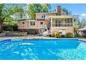 Stunning backyard features a large in-ground pool, screened in porch, and well-manicured landscaping at 2917 Rockbridge Rd, Marietta, GA 30066