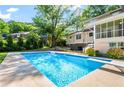 Private backyard with in-ground pool, hot tub, and lush green landscaping at 2917 Rockbridge Rd, Marietta, GA 30066