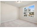 Well-lit bedroom with carpet flooring and a large window offering ample natural light at 3564 Arrow Root Cir, Loganville, GA 30052