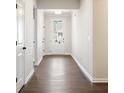 Bright hallway with wood flooring leading towards the front door at 3564 Arrow Root Cir, Loganville, GA 30052