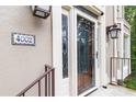 Welcoming entryway showcasing a decorative address tile, classic lighting, and a beautifully crafted glass door at 4002 Turnstone Nw Dr, Kennesaw, GA 30152