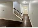 Bright entryway with hardwood floors, visible stairs, and leading to the front door at 2249 Knoxhill Se Vw, Smyrna, GA 30082