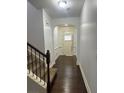 View of the light and airy foyer with dark wood flooring and stairs at 2249 Knoxhill Se Vw, Smyrna, GA 30082