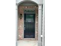 View of brick-framed doorway with black door and columns with visible house number at 2249 Knoxhill Se Vw, Smyrna, GA 30082
