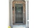 A gray front door with the house number 2249 between two white columns on a brick house at 2249 Knoxhill Se Vw, Smyrna, GA 30082