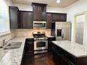 Kitchen with stainless appliances, granite countertops, dark cabinets and hardwood floors at 2249 Knoxhill Se Vw, Smyrna, GA 30082