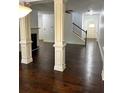 Living room featuring hardwood floors, decorative columns and a staircase at 2249 Knoxhill Se Vw, Smyrna, GA 30082