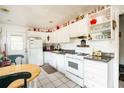 Functional kitchen with white cabinets, classic appliances, and adjacent dining area with tile floor at 311 Henry Aaron Ave, Atlanta, GA 30310