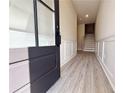 Bright foyer with modern wood flooring, decorative wainscotting, and a staircase to the upper level at 5710 Urban Village Way # 6, Tucker, GA 30084