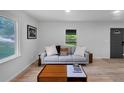 Cozy living room featuring hardwood floors, a sofa, and bright light at 3807 Greenhill Dr, Chamblee, GA 30341