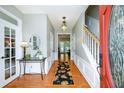 Welcoming foyer with hardwood floors, a staircase, neutral walls, and a view into other rooms at 515 Rosedown Way, Lawrenceville, GA 30043