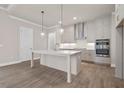 Bright kitchen with stainless steel appliances, a large center island with quartz countertops at 517 Godfrey Dr, Cumming, GA 30040