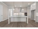 Stylish kitchen featuring custom cabinets, a large island, and modern pendant lighting at 517 Godfrey Dr, Cumming, GA 30040