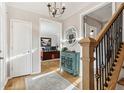 Inviting foyer with hardwood floors, staircase, and an office view, creating a warm and welcoming entrance at 5305 Redfield Way, Cumming, GA 30028